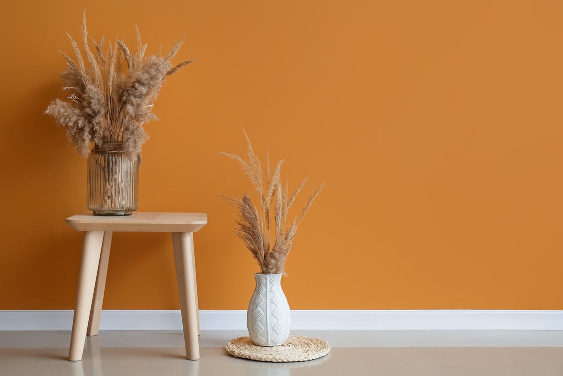 Wooden Table with Vases near Color Wall